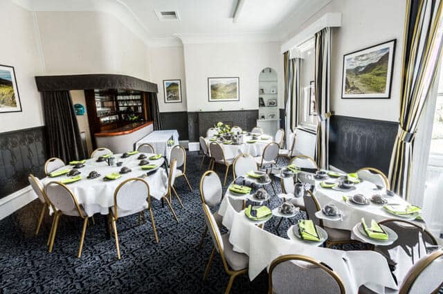 Function room at JW Binks laid out with tables and chairs for a wake